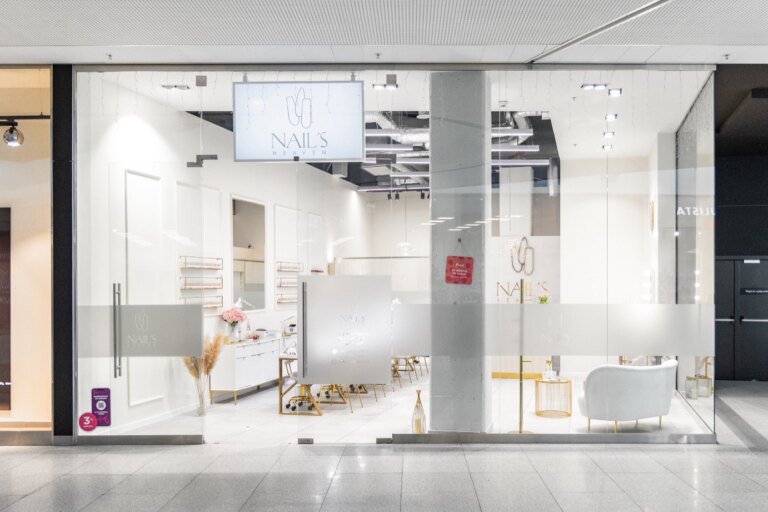 Wejście do salonu paznokci Nails Heaven w Katowicach - przeszklona witryna z podświetlanym logo w galerii handlowej.